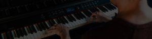 Man playing Williams Overture III digital console piano black.