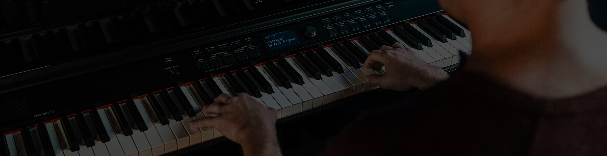 Man playing Williams Overture III digital console piano black.