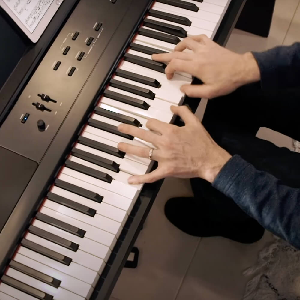 Williams Allegro III digital piano with hand of pianist.