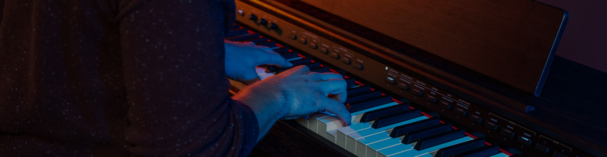 Man playing the Williams Rhapsody III digital piano.